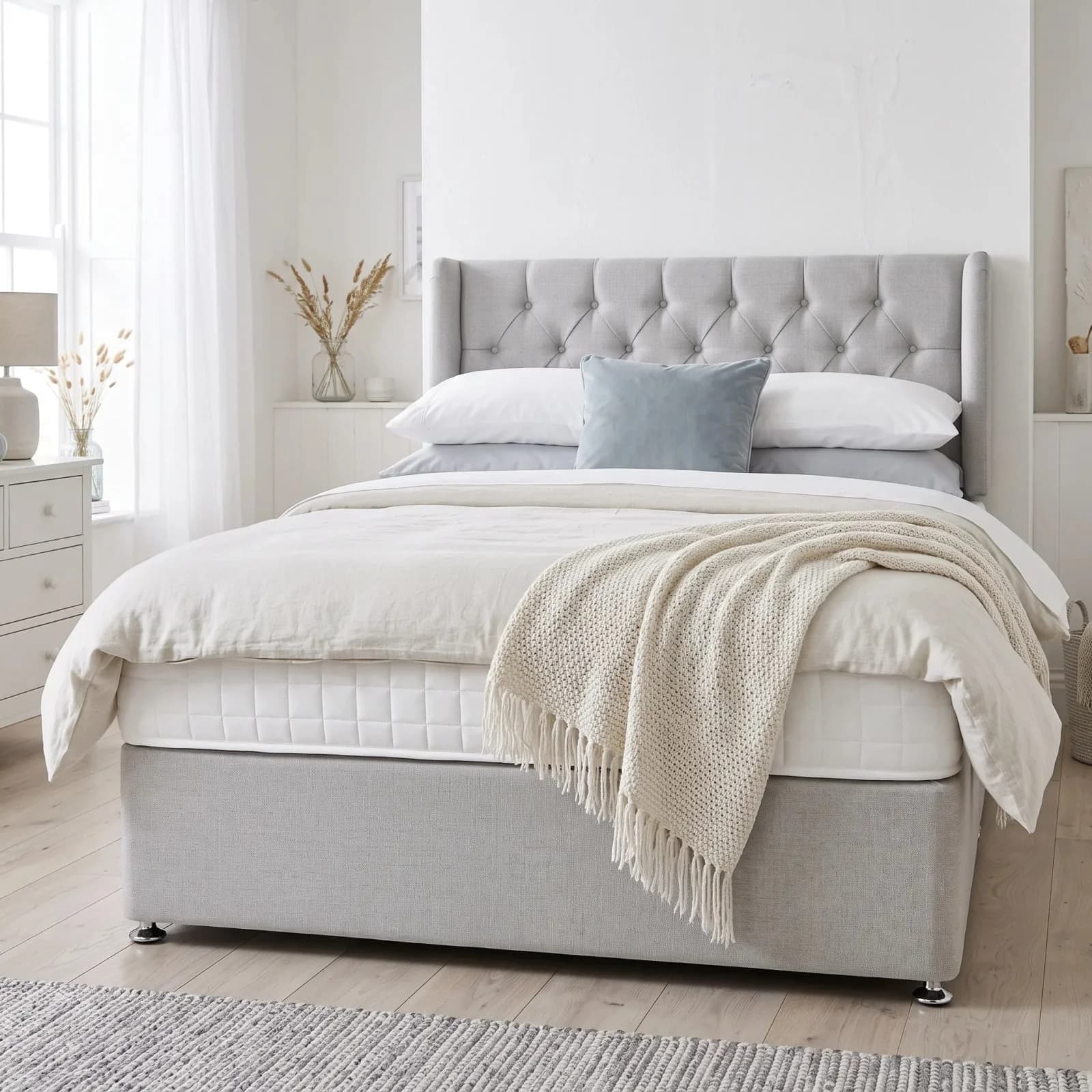 Luxury Pocket 1000 divan bed with a low grey upholstered headboard, quilted pocket-sprung mattress and chrome glide feet, in a bright bedroom